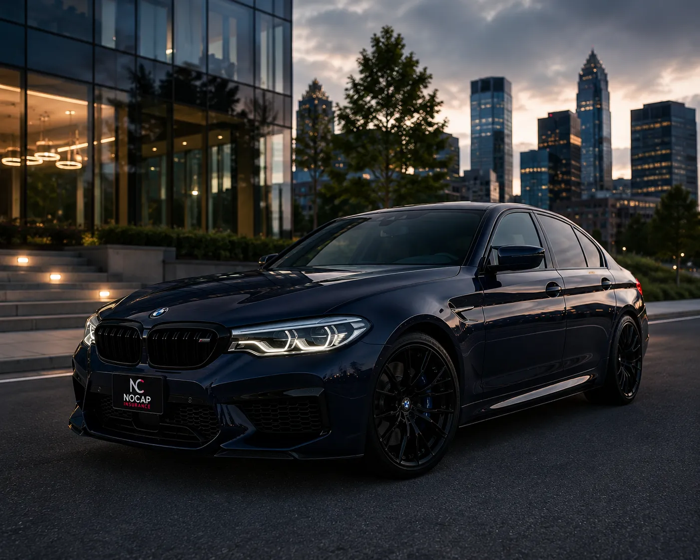 A dark sedan parked at dusk with the city behind it.